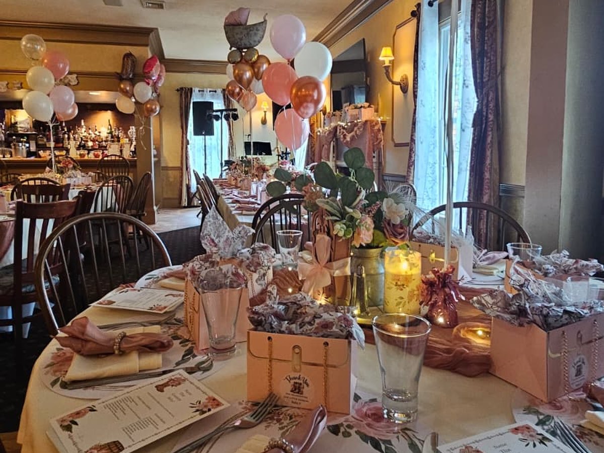 Baby shower tables with rose gold balloons and floral centerpieces at Silvio's Villa